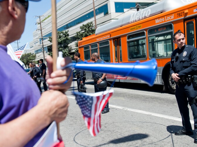 LAPD officers stand along Sepulveda Boulevard as a press conference takes place. Hundreds of immigration reform supporters took part in a march on Wednesday to Senator Diane Feinstein's LA office. The march coincides with a immigration reform rally in Washington D.C.