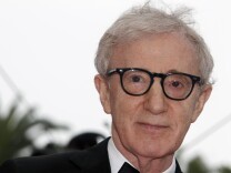 Director Woody Allen poses on the red carpet before the opening ceremony and the screening of "Midnight in Paris" presented out-of- competition at the 64th Cannes Film Festival on May 11, 2011 in Cannes.