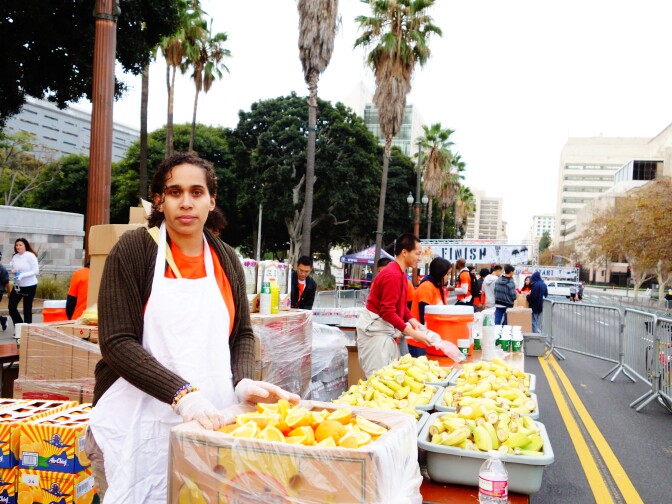 Volunteer Kathryn Lewis arranges fruit to give to runners at Turkey Trot LA, a 5K/10K race at Downtown Los Angeles, Nov. 28, 2013.