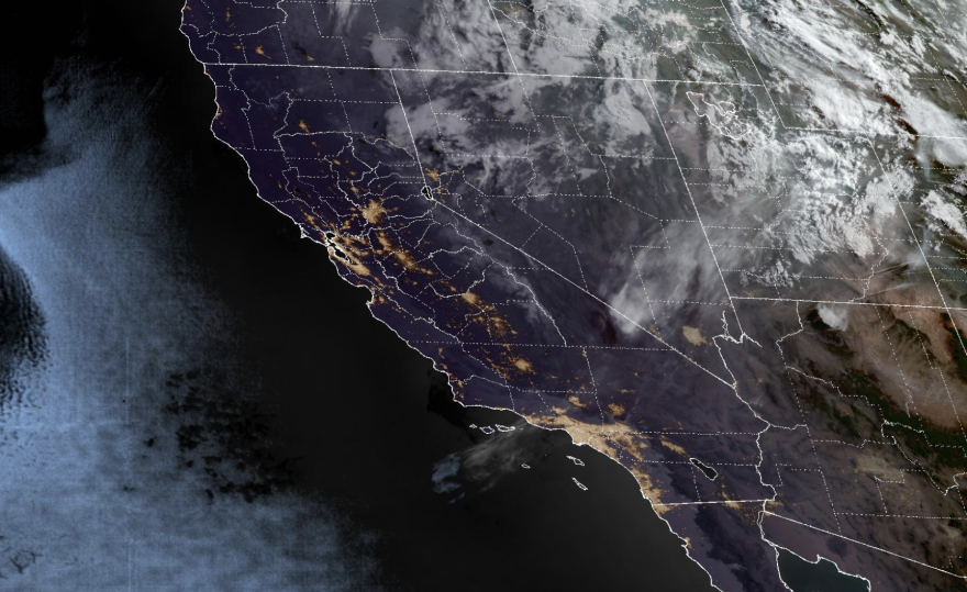 A map showing California and the west coast for weather. It is mostly black with patches of light yellow over the coastal area, and white over Nevada, Idaho and Montana.