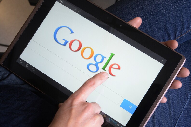 Caption:This picture taken on May 13, 2013 in the French western city of Rennes shows a woman choosing Google Search (or Google Web Search) web search engine front page on her tablet. A report by a French expert panel published on May 13, 2013 recommended imposing taxes on smartphones and tablets but rejected a call for search engine Google to be charged for linking to media content. The nine-member panel, headed by respected journalist and businessman Pierre Lescure, said in the keenly awaited report that the revenue gained from the proposed new taxes could help fund artistic and creative ventures. AFP PHOTO / DAMIEN MEYER (Photo credit should read DAMIEN MEYER/AFP/Getty Images)
