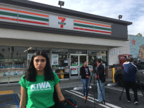 Scarlett De Leon with the Koreatown Immigrant Workers Association was one of about 50 immigrant advocates who gathered Tuesday morning at a 7-Eleven store in Koreatown to protest recent immigration enforcement sweeps at the convenience stores nationwide last week.