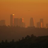 The downtown skyline is enveloped in smog shortly before sunset in Los Angeles, California.