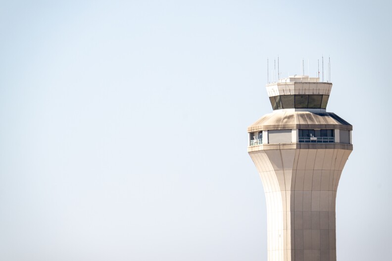 A close up of a traffic control tower with a clear sky in the background.