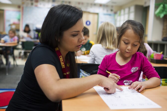 Teacher Diana Enciso works with kindergartner Milagros Ruiz on a Spanish-language exercise with words that start with "R" at George Brown Elementary, a dual-language school in San Bernardino, on Monday morning, May 4, 2015. “The teachers actually have to go around and listen to the kids speak,” says Maribel Lopez-Tyus, the school's principal.