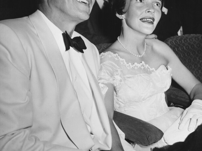 Actor Ronald Reagan and his wife Nancy sitting together holding hands at a party in Hollywood circa 1955.