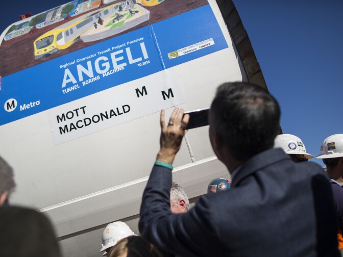 Mayor Eric Garcetti takes a photo on his phone of a segment of the tunnel boring machine what will be used to dig Metro's Regional Connector Transit Project during a naming ceremony in Little Tokyo on Wednesday morning, Oct. 29, 2016 for the machine.