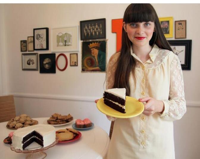 Clara Polito holds a slice of homemade cake in her dining room.