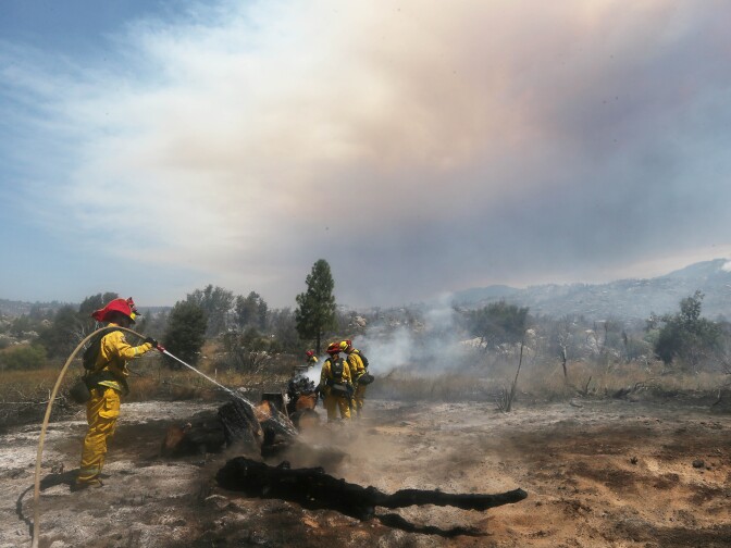 IDYLLWILD, CA - JULY 26:  Firefighters work as the Cranston Fire burns in San Bernardino National Forest on July 26, 2018 near Idyllwild, California. Fire crews are battling the 4,700-acre fire in the midst of a heat wave.  (Photo by Mario Tama/Getty Images)