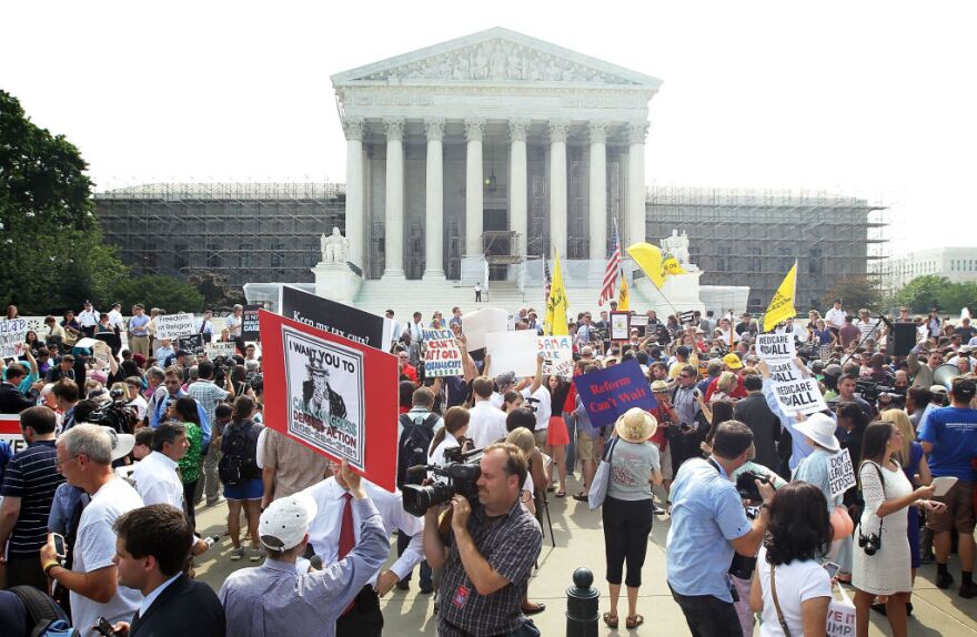 Obamacare supporters and protesters gather in front of the U.S. Supreme Court to find out the ruling on the Affordable Health Act June 28, 2012 in front of the U.S. Supreme Court in Washington, DC. The Supreme Court has upheld the whole healthcare law of the Obama Administration.