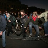 Protesters from Occupy Oakland -the local offshoot of Occupy Wall Street- knock down fences to escape from the police after they were surrounded to be detained on a vacant lot in Oakland on January 28, 2012.  Police have fired tear gas and arrested more than 100 people as anti-Wall Street protesters tried but failed to take over downtown buildings, including city hall, in Oakland, California.  AFP PHOTO / Kimihiro Hoshino (Photo credit should read KIMIHIRO HOSHINO/AFP/Getty Images)