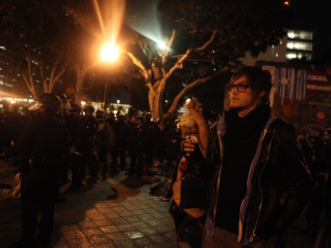 An Occupy Los Angeles protester stood within the police cordon as the LAPD announced an unlawful assembly and prepared to arrest demonstrators.