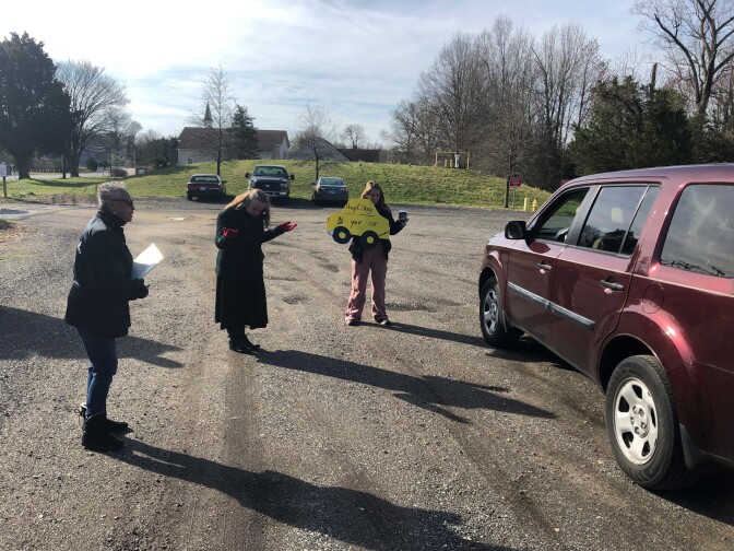 Lay ministers Darlene Washington (from left) and Jackie Waymire and Pastor Faith Wilkerson pray with a couple in the Centenary Methodist Church parking lot in Shady Side, Md.