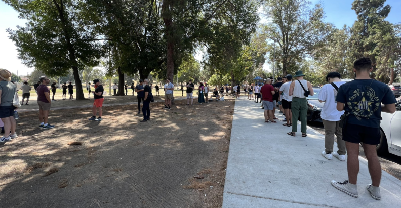 People stand outside in long lines to receive the monkeypox vaccine.