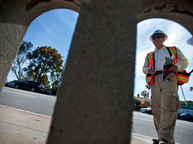 Caltrans' Bing Wu first checks the top of the bridge, including the railing and the road. 
