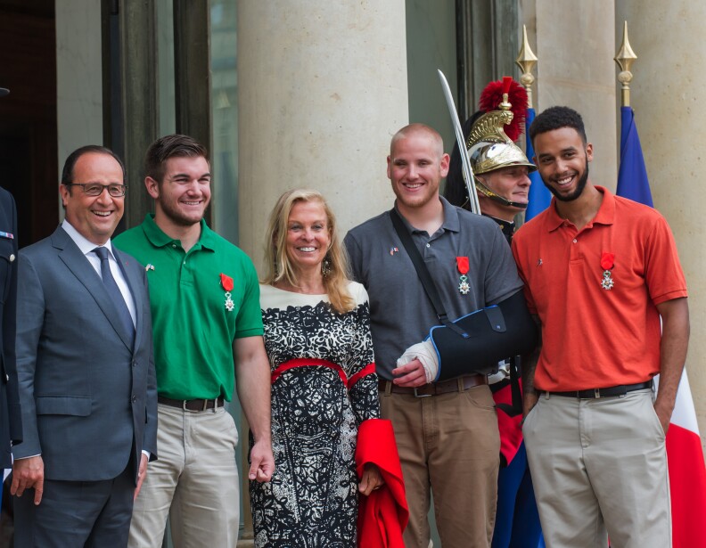 From left : French President, Francois Hollande, U.S. National Guardsman from Roseburg, Oregon, Alek Skarlatos, U.S. Ambassador to France Jane D. Hartley, U.S. Airman Spencer Stone and Anthony Sadler, a senior at Sacramento University in California, pose for photographers as they leave the Elysee Palace in Paris, France, after being awarded with the French Legion of Honor by French President, Francois Hollande, Monday, Aug. 24, 2015. French President Francois Hollande and a bevy of officials are presenting the Americans with the prestigious Legion of Honor on Monday. The three American travelers say they relied on gut instinct and a close bond forged over years of friendship as they took down a heavily armed man on a passenger train speeding through Belgium. (AP Photo/Kamil Zihnioglu)