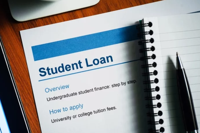 Document under a notebook with a letterhead reading "Student Loan"
