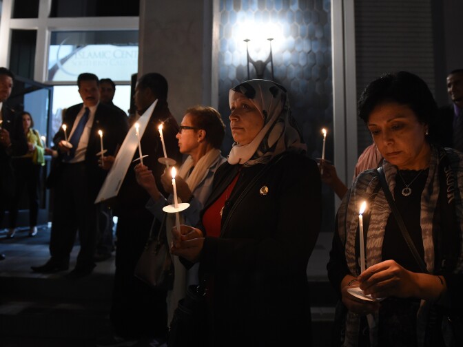 Muslims hold a candlelight vigil at the Islamic Center of Southern California in Los Angeles on February 12, 2015  for the three Muslim students who were fatally shot in  North Carolina.   