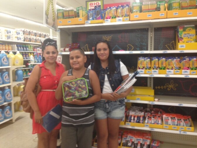 Renee Martinez and her two kids, Domanick and Alyssa, shop for school supplies at Kmart in Temple City. Martinez, who is unemployed, said she is cutting back on the amount of money spent on school supplies this year.