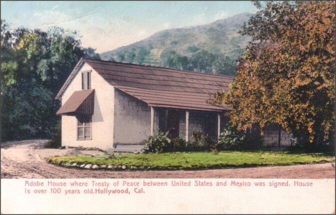 Photo of a tinted postcard of the original adobe ranch house, with Cahuenga Peak in the background, and text description: Adobe House where Treaty of Peace between United States and Mexico was signed. House is over 100 years old. Hollywood, CA