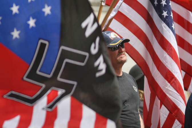 LOS ANGELES, CA - APRIL 17:  Members of the National Socialist Movement (NSM) rally near City Hall on April 17, 2010 in Los Angeles, California. An NSM anti-illegal immigration rally in October in Riverside, California resulted in fights between the neo-Nazis and counter-protesters.   (Photo by David McNew/Getty Images)