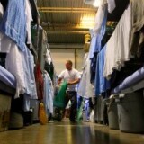 An inmate at the Mule Creek State Prison walks near his bunk bed in a gymnasium that was modified to house prisoners in Ione, California.