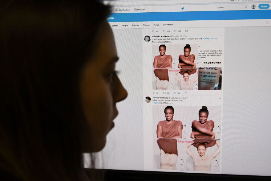 A posed picture taken in London on October 9, 2017 shows a journalist looking at screenshots retweeted by Twitter users on the social networking site of a video-clip used in an online advert by the personal care brand Dove that originally appeared on social networking website Facebook and has since been removed amid accusations of racism. 
Personal care brand Dove has apologised for an advert that showed a black woman removing a top to reveal a white woman underneath, following accusations of racism. The three-second video clip appeared in the United States on the social networking site Facebook. 
 / AFP PHOTO / Daniel SORABJI        (Photo credit should read DANIEL SORABJI/AFP/Getty Images)