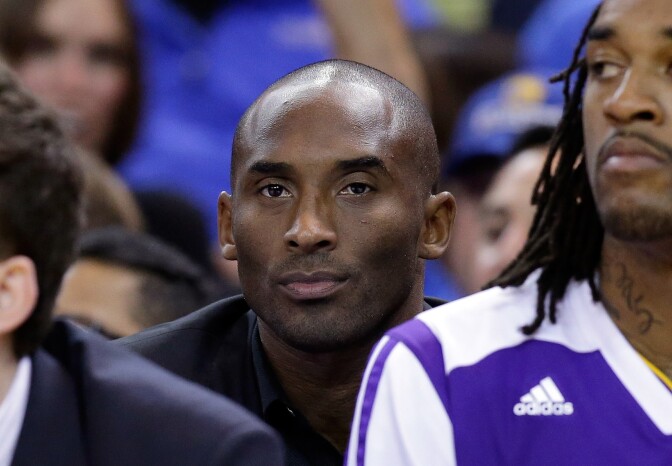 Kobe Bryant sits on the bench during their game against the Golden State Warriors at ORACLE Arena on October 30, 2013 in Oakland, California. Bryant has been out all season as he recovers from an Achilles injury. 