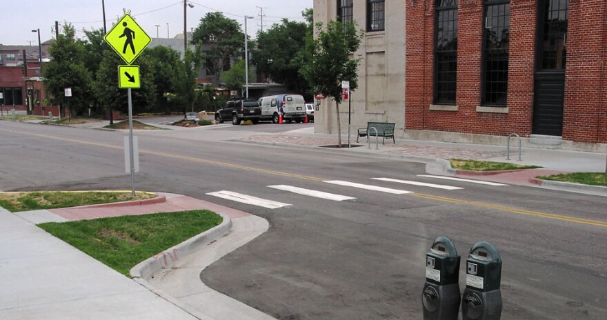 A 'corner bulb out' extends the sidewalk into the street, shortening the distance a pedestrian has to walk, and helping slow auto traffic.