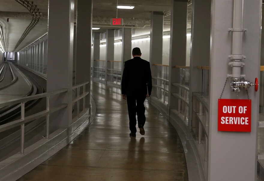 Senator Joe Manchin (D-WV) walks along the Senate subway at the U.S. Capitol October 3, 2013 in Washington, DC. Democrats and Republicans are still at a stalemate on funding for the federal government as the shut down goes into third day.  