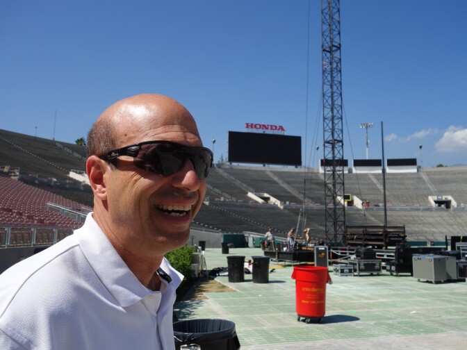 Darryl Dunn, general manager of the Rose Bowl Operating Co., watches roadies install lights and sound at the stadium.