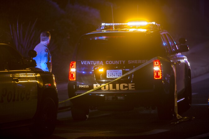 A Ventura County Sheriffs officer stands near a vehicle near the Borderline Bar and Grill, where a mass shooting occurred on November 7, 2018 in Thousand Oaks, California.