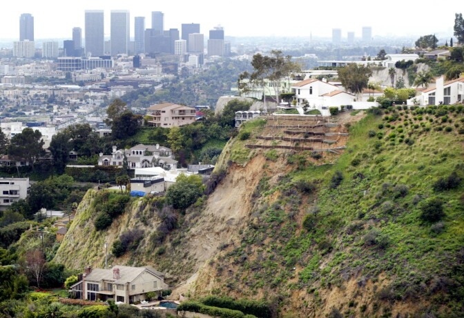 LOS ANGELES - FEBRUARY 28:  Homes in the Hollywood Hills are threatened by landslide brought on by record rainfall February 28, 2005 in Los Angeles, California. At least three multi-million dollar homes have been evacuated and residents have been encouraged to evacuate near Mount Olympus with more rain forecast. The Century City skyline can be seen in the background.  (Photo by J. Emilio Flores/Getty Images)