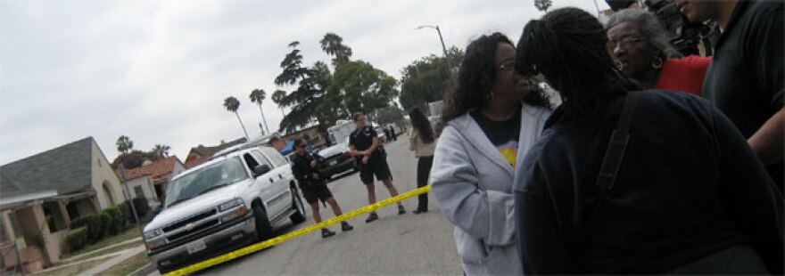 Police and local residents gather near the house of Lonnie Franklin Jr., 57, in South Los Angeles. 