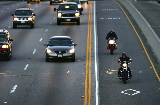 Two motorcyclists drive in the High Occupancy Vehicle (HOV) lane, also called the diamond or commuter lane, on the 118 or Ronald Reagan Freeway on February 3, 2005 near Simi Valley, California.