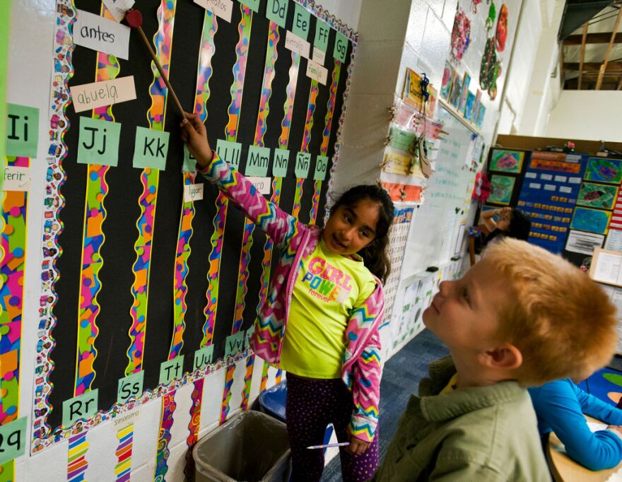 Spanish-primary student Jessica Ortiz helps English-primary student Jack Barnes, both second graders, learn Spanish vocabulary words during the Spanish Language Arts portion.