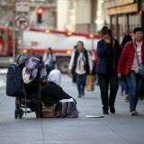SAN FRANCISCO, CALIFORNIA - NOVEMBER 25: A homeless woman begs for change as pedestrians walk by on November 25, 2019 in San Francisco, California. The Trump administration could be preparing to replace recently dismissed executive director of the U.S. Interagency Council on Homelessness Matthew Doherty and deliver a new agenda to combat homelessness in cities like San Francisco and Los Angeles. (Photo by Justin Sullivan/Getty Images)