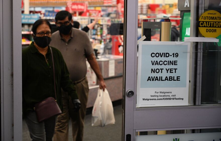 A sign on the entrance to a pharmacy reads "Covid-19 Vaccine Not Yet Available", November 23, 2020 in Burbank, California. - British drugs group AstraZeneca and the University of Oxford said they will seek regulatory approval for their coronavirus vaccine, adding to hopes that a post-pandemic economy could be in the offing following similar announcements by Pfizer/BioNTech and Moderna. (Photo by Robyn Beck / AFP) (Photo by ROBYN BECK/AFP via Getty Images)