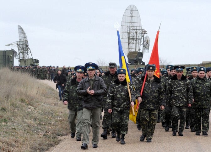 Ukrainian air force pilots march in their air base in Belbek, near Sevastopol, on March 4, 2014. Russian forces surrounding the air base in Belbek fired warning shots at Ukrainian servicemen trying to approach on March 4, a Ukrainian officer inside told AFP. Russian forces have surrounded Ukrainian military bases across Crimea as the Russian-speaking autonomous region has been thrown into turmoil following the ouster last month of Moscow-backed president Viktor Yanukovych. Ukrainian officials said on March 3 that Russia had given Ukrainian soldiers in Crimea an ultimatum to surrender or face an all-out assault, although Russia denounced the claim as 'complete nonsense'.