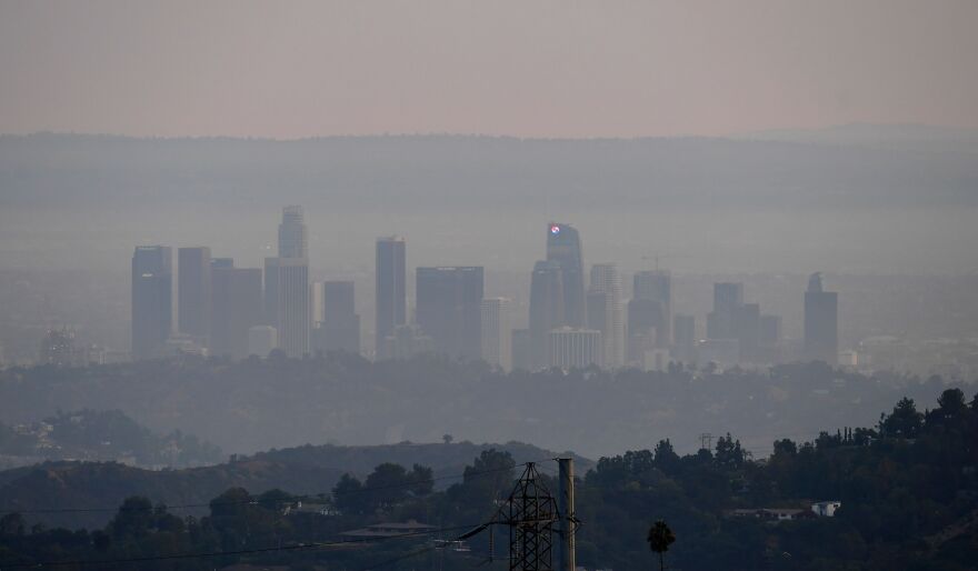 The downtown Los Angeles skyline is shrouded in haze