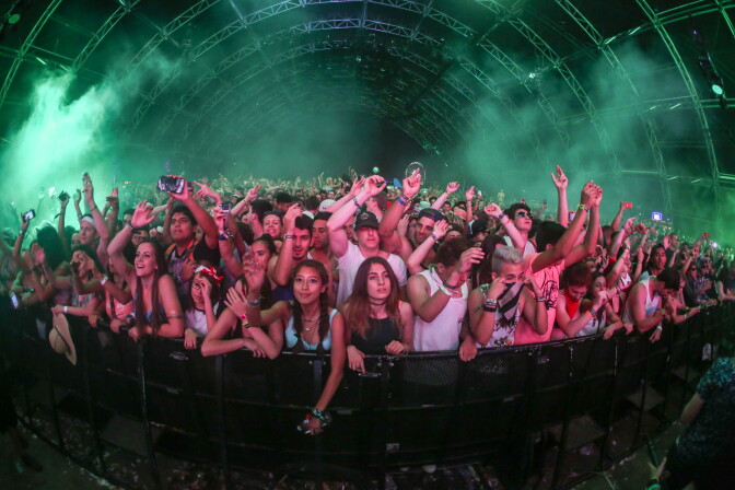 Festival goers enjoy the music in the Sahara Tent during David Guetta at the 2015 Coachella Music and Arts Festival on Sunday, April 12, 2015, in Indio, Calif. (Photo by Rich Fury/Invision/AP)