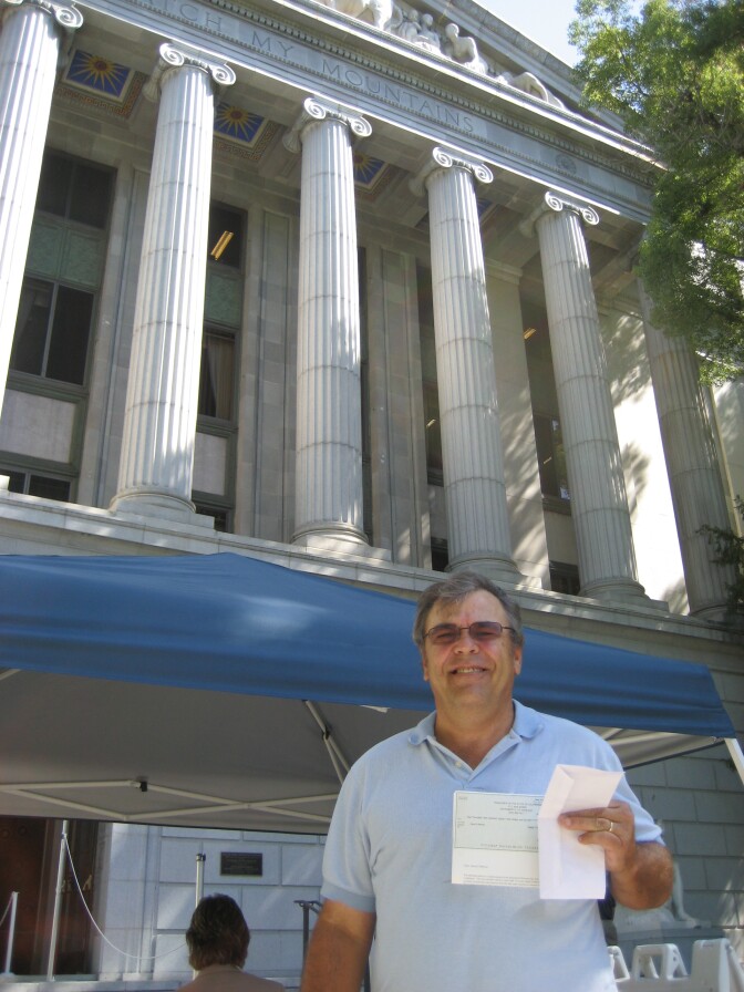 Independent contractor Dave Melrose traded his California IOUs for a check for payment at the State Treasurers Office in Sacramento. 