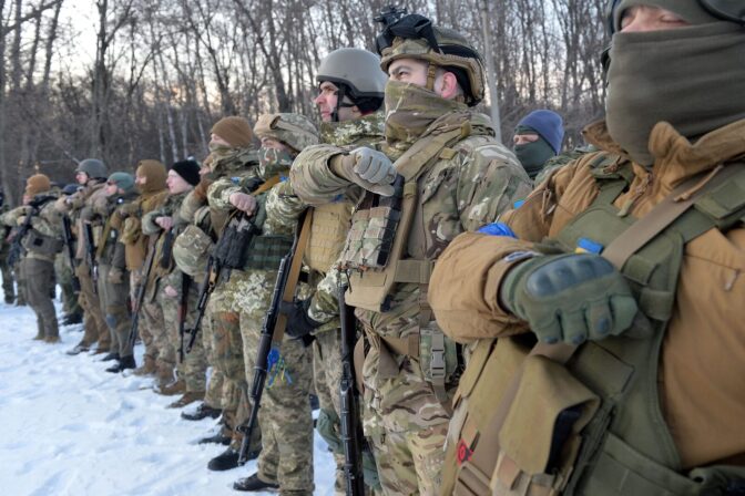 Servicemen of Ukraine's Azov Battalion pray in the Ukraine's second-biggest city of Kharkiv, following Russia's invasion of Ukraine.