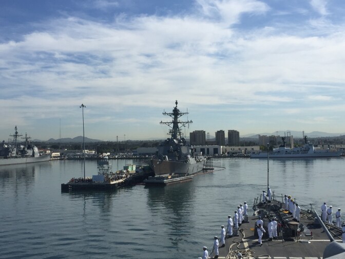 San Diego begins to recede as USS Decatur backs out of her berth and turns her bow into the channel.