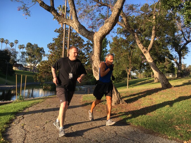 Judge Craig J. Mitchell (right) with a member of the Skid Row Running Club.