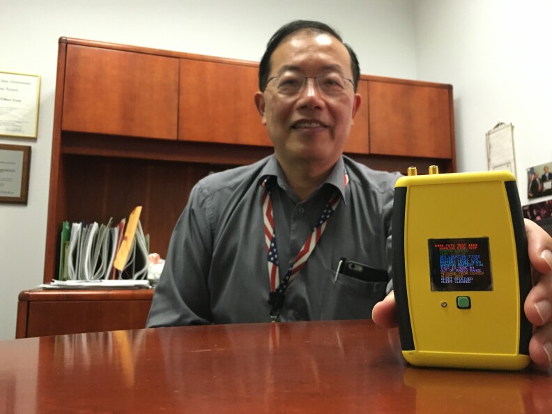 Ed Chow with NASA's Jet Propulsion Laboratory showing off the Personal Alert and Tracking System he helped develop for firefighters.