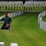 Lady's Island Intermediate School fifth grade student Joshua Desmore places an American flag at a marker at the Beaufort National Cemetery May 27, 2011 in Beaufort, South Carolina.