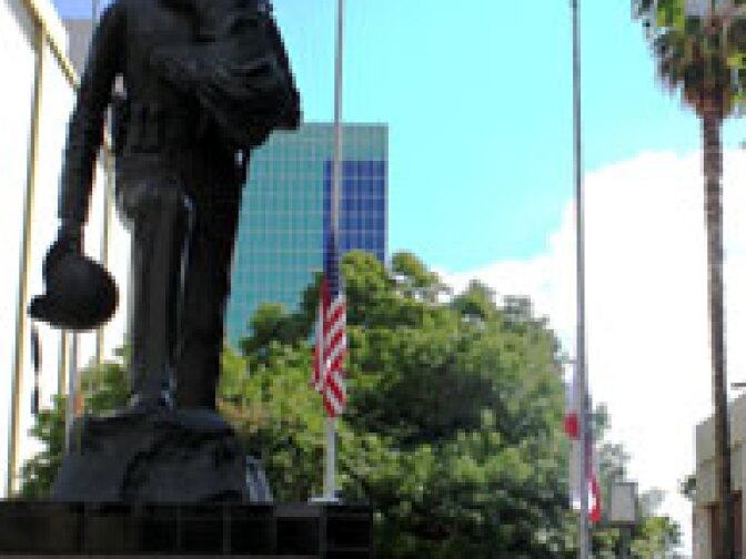 Flags outside Riverside Police headquarters were lowered to half-staff Monday following the shooting death of Officer Ryan Bonaminio