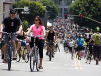 File: Riders climb Wilshire Boulevard in downtown L.A. during the seventh CicLAvia event on June 23, 2013.