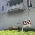 A "for rent" sign hangs near a discarded mattresses outside an apartment building in the city of Los Angeles. 